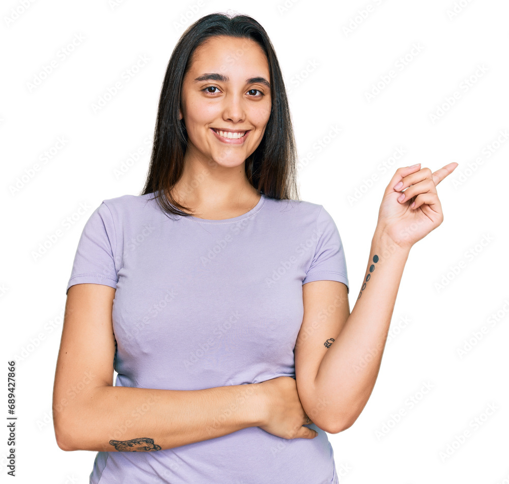 Young hispanic woman wearing casual clothes smiling happy pointing with hand and finger to the side Young hispanic woman wearing casual clothes smiling happy pointing with hand and finger to the side