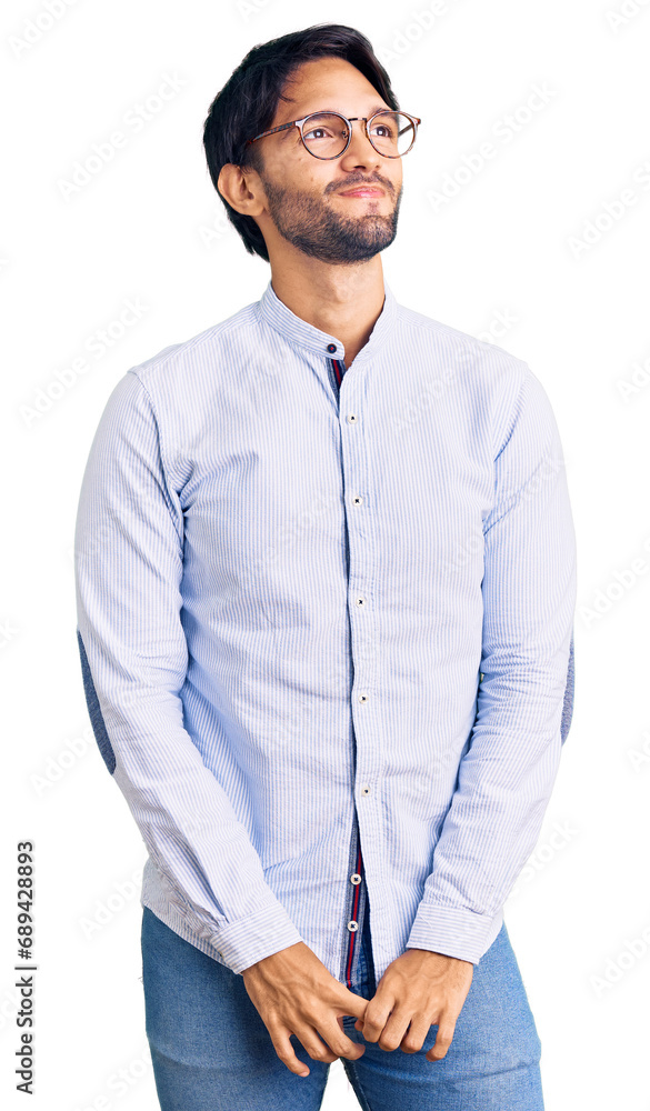 Handsome hispanic man wearing business shirt and glasses smiling looking to the side and staring away thinking. Handsome hispanic man wearing business shirt and glasses smiling looking to the side and staring away thinking.