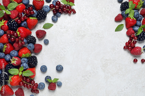 Fototapeta Naklejka Na Ścianę i Meble -  Many different fresh ripe berries on white textured table, flat lay. Space for text