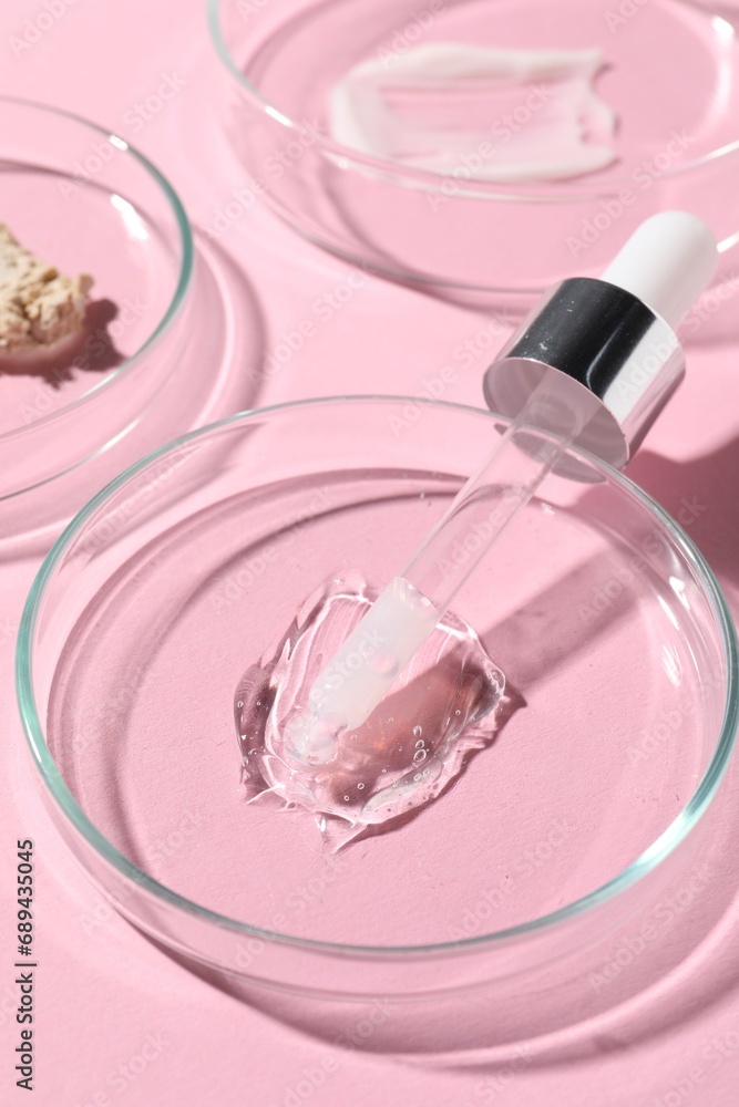 Pipette, cosmetic serum and petri dishes with samples on pink background, closeup Pipette, cosmetic serum and petri dishes with samples on pink background, closeup