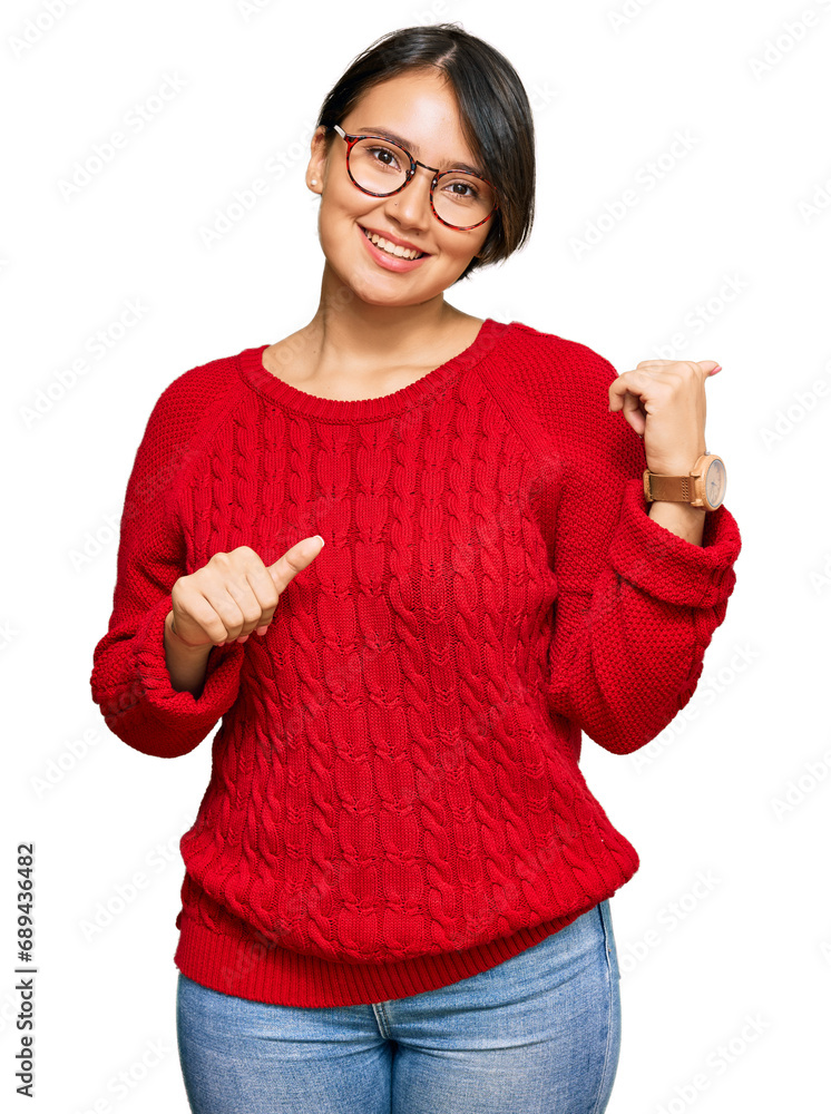Young beautiful hispanic woman with short hair wearing casual sweater and glasses pointing to the back behind with hand and thumbs up, smiling confident Young beautiful hispanic woman with short hair wearing casual sweater and glasses pointing to the back behind with hand and thumbs up, smiling confident