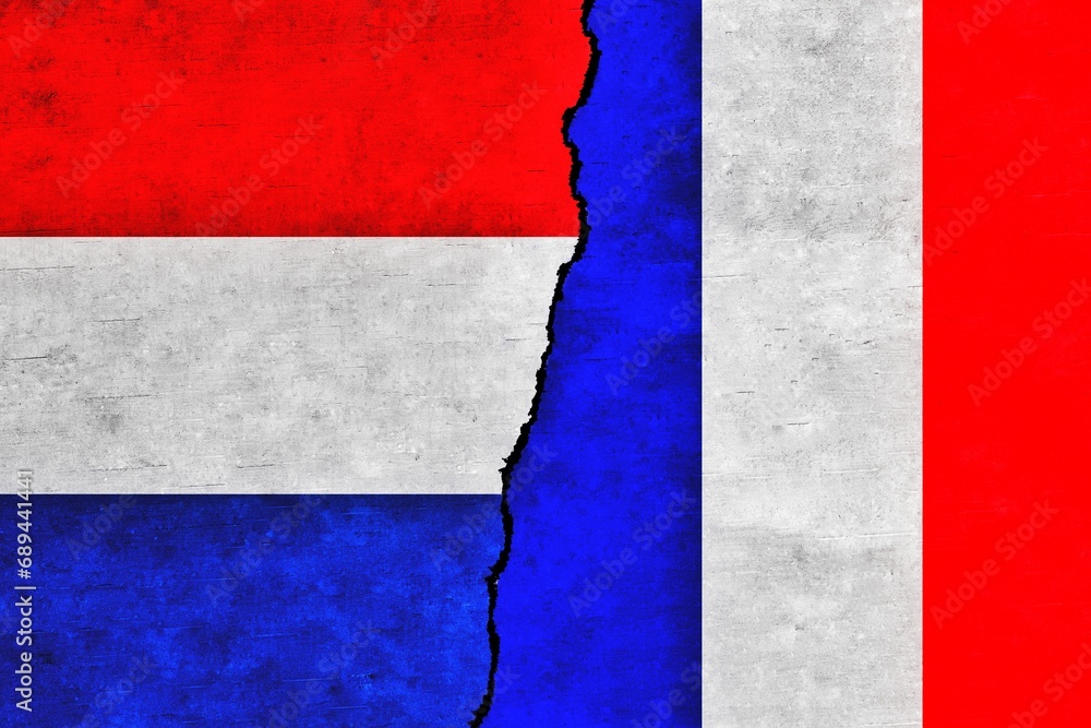 France and Netherlands painted flags on a wall with a crack.Netherlands and France relations. France and Netherlands flags together France and Netherlands painted flags on a wall with a crack.Netherlands and France relations. France and Netherlands flags together