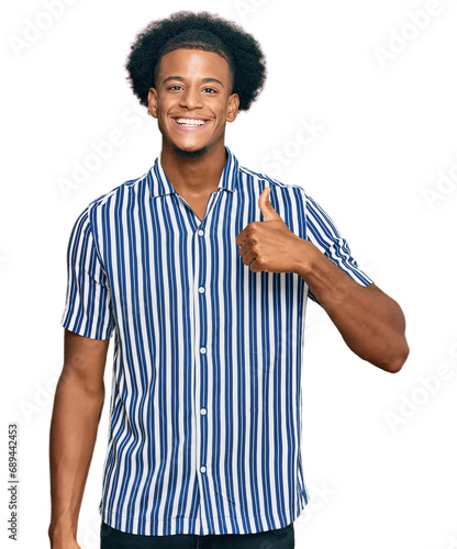 African american man with afro hair wearing casual clothes smiling happy and positive, thumb up doing excellent and approval sign