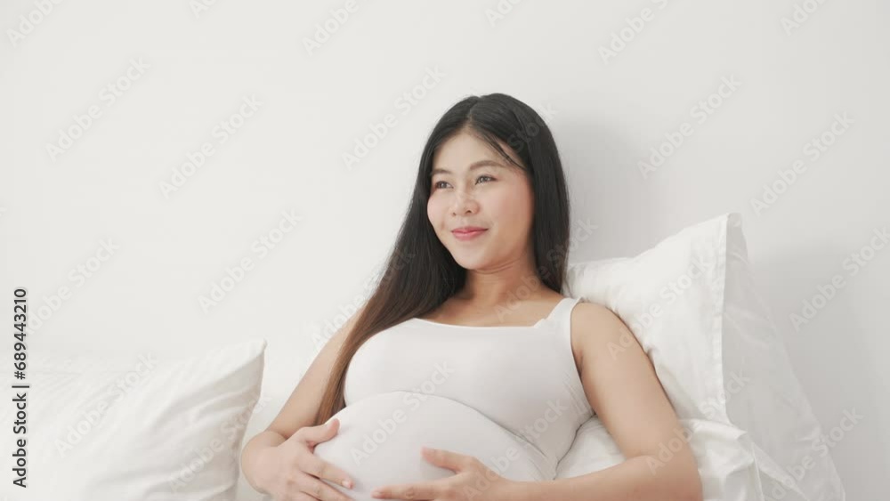 beautiful pregnant woman, sitting on bed in bedroom, preparing to give a birth beautiful pregnant woman, sitting on bed in bedroom, preparing to give a birth