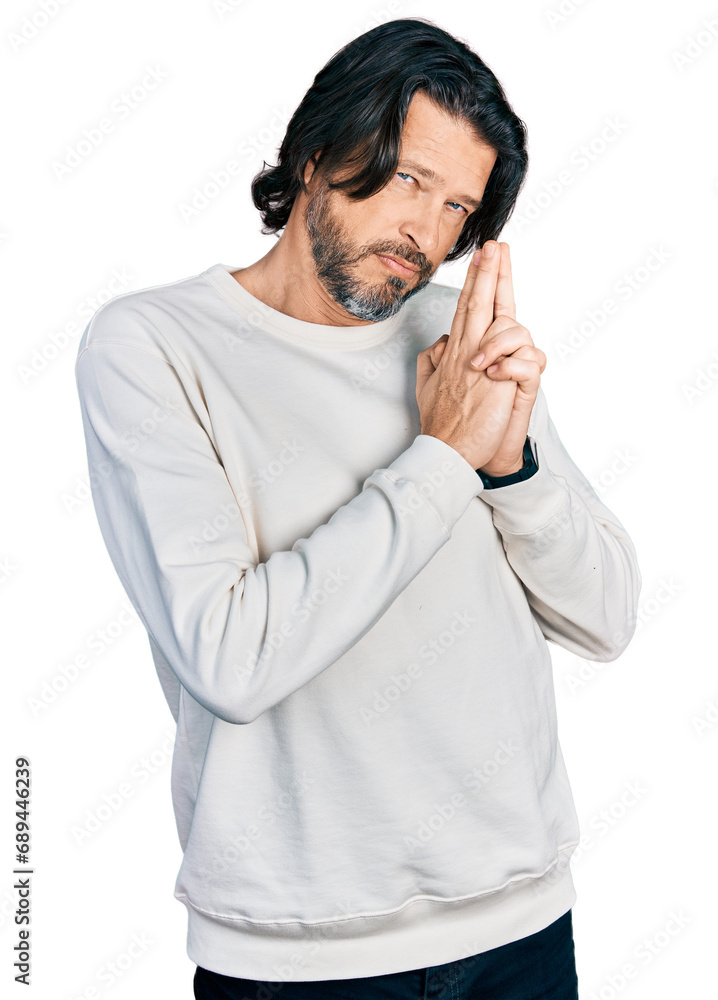 Middle age caucasian man wearing casual clothes holding symbolic gun with hand gesture, playing killing shooting weapons, angry face Middle age caucasian man wearing casual clothes holding symbolic gun with hand gesture, playing killing shooting weapons, angry face