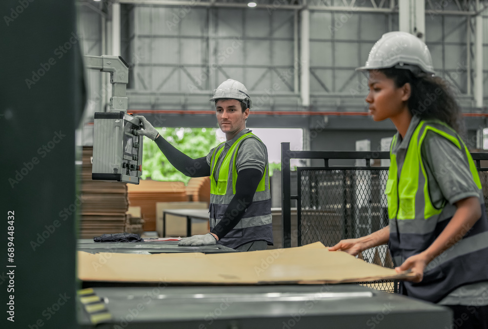 Technician ensures machinery stays regular, inspect error for smooth operations in cardboard factory Technician ensures machinery stays regular, inspect error for smooth operations in cardboard factory