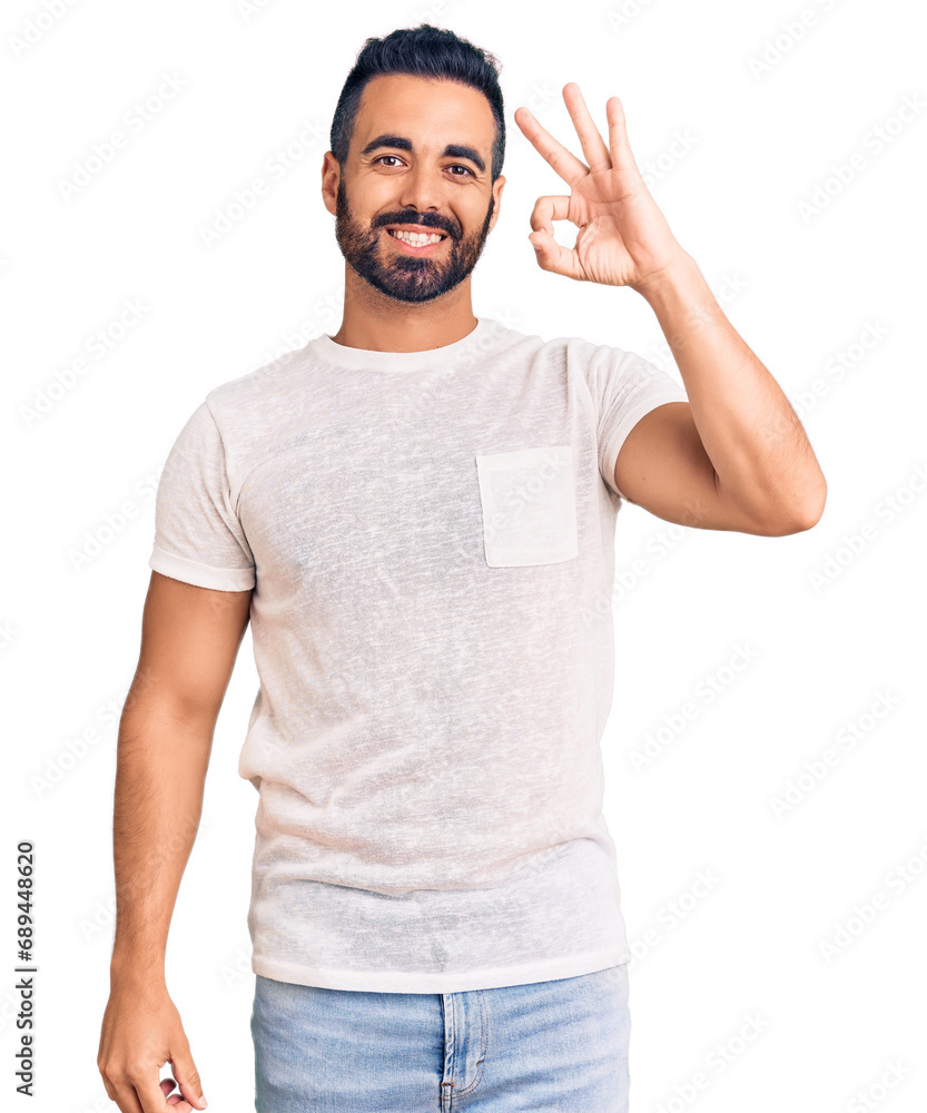 Young hispanic man wearing casual clothes smiling positive doing ok sign with hand and fingers. successful expression. Young hispanic man wearing casual clothes smiling positive doing ok sign with hand and fingers. successful expression.