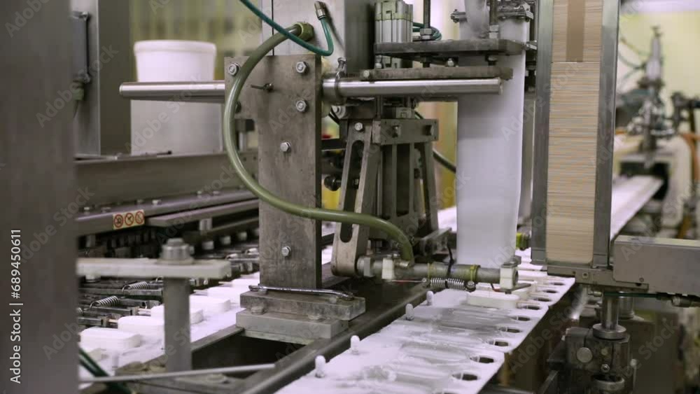 Food industry. Automation and technology. View of a cream popsicle factory machine. Food industry. Automation and technology. View of a cream popsicle factory machine.