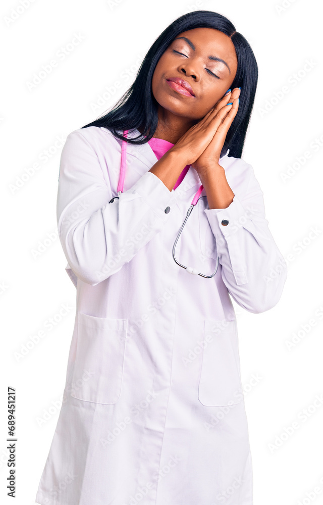 Young african american woman wearing doctor stethoscope sleeping tired dreaming and posing with hands together while smiling with closed eyes. Young african american woman wearing doctor stethoscope sleeping tired dreaming and posing with hands together while smiling with closed eyes.