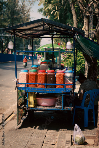 Food cart selling fruits and chili dip called Ombel bok on the side of the street, authentic khmer or cambodian cuisine and culture