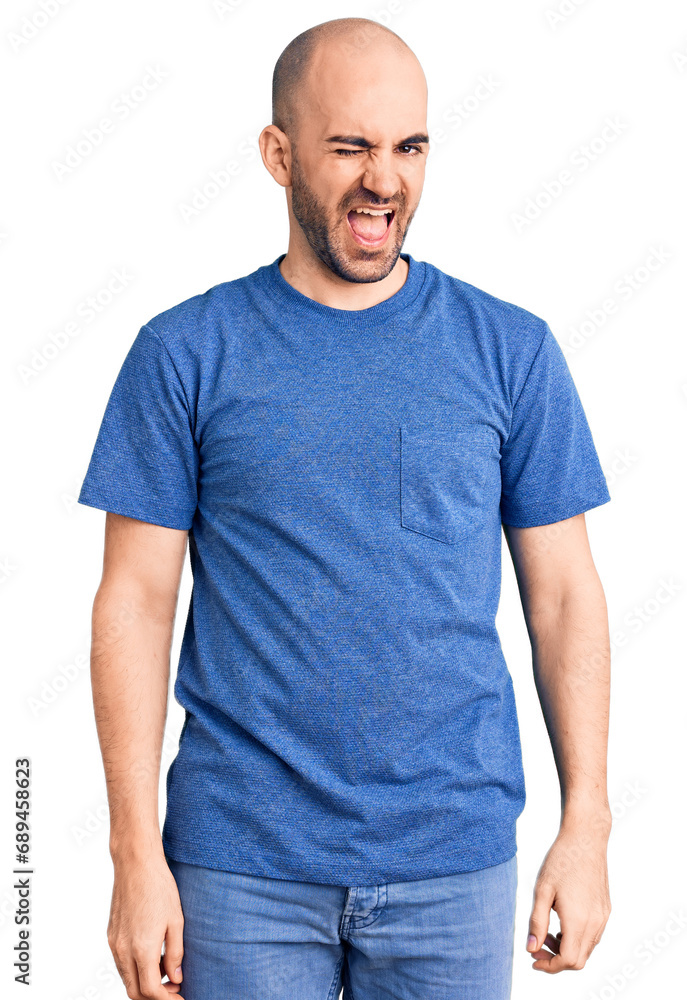Young handsome man wearing casual t shirt winking looking at the camera with sexy expression, cheerful and happy face. Young handsome man wearing casual t shirt winking looking at the camera with sexy expression, cheerful and happy face.
