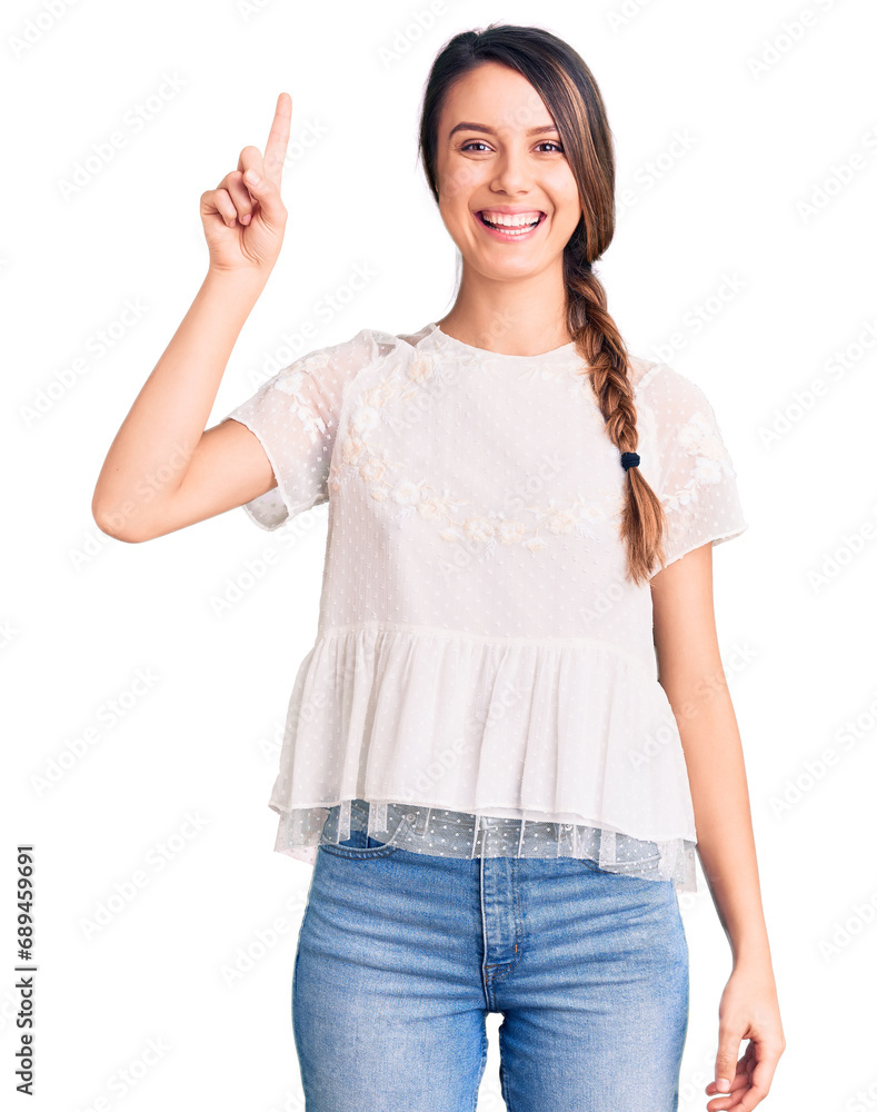 Young beautiful girl wearing casual t shirt pointing finger up with successful idea. exited and happy. number one. Young beautiful girl wearing casual t shirt pointing finger up with successful idea. exited and happy. number one.