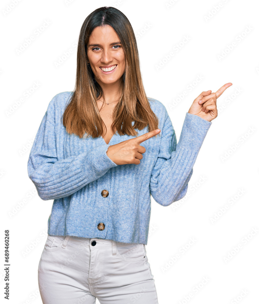 Young woman wearing casual clothes smiling and looking at the camera pointing with two hands and fingers to the side. Young woman wearing casual clothes smiling and looking at the camera pointing with two hands and fingers to the side.
