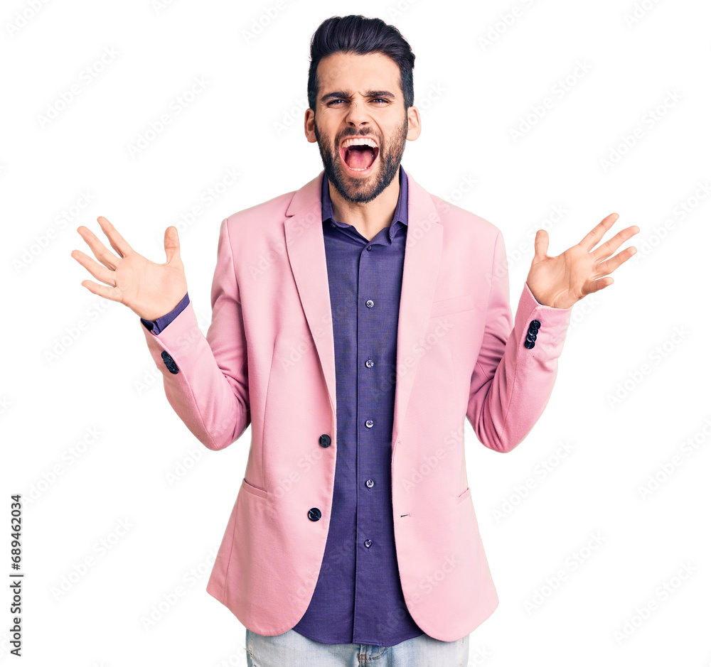 Young handsome man with beard wearing elegant jacket celebrating mad and crazy for success with arms raised and closed eyes screaming excited. winner concept Young handsome man with beard wearing elegant jacket celebrating mad and crazy for success with arms raised and closed eyes screaming excited. winner concept