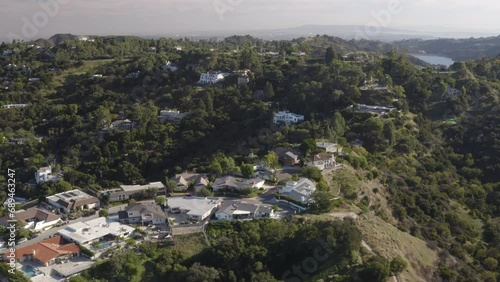 4K cinematic drone shot of houses in Beverly Hills California with the Stone Canyon Reservoir in the background.