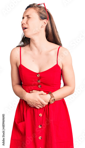 Young beautiful blonde woman wearing casual dress with hand on stomach because nausea, painful disease feeling unwell. ache concept. © Krakenimages.com