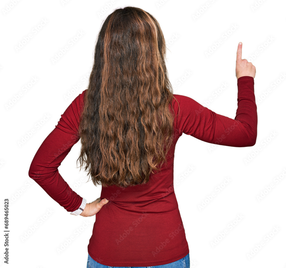Young blonde woman wearing casual clothes posing backwards pointing ahead with finger hand Young blonde woman wearing casual clothes posing backwards pointing ahead with finger hand