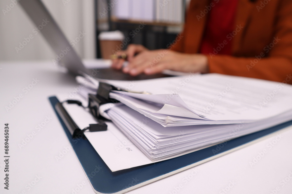 close up businessman hand analyzing income to pay personal income tax. close up businessman hand analyzing income to pay personal income tax.