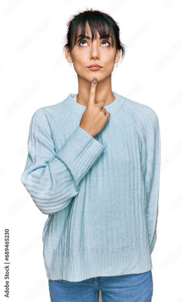 Young hispanic woman wearing casual clothes thinking concentrated about doubt with finger on chin and looking up wondering Young hispanic woman wearing casual clothes thinking concentrated about doubt with finger on chin and looking up wondering