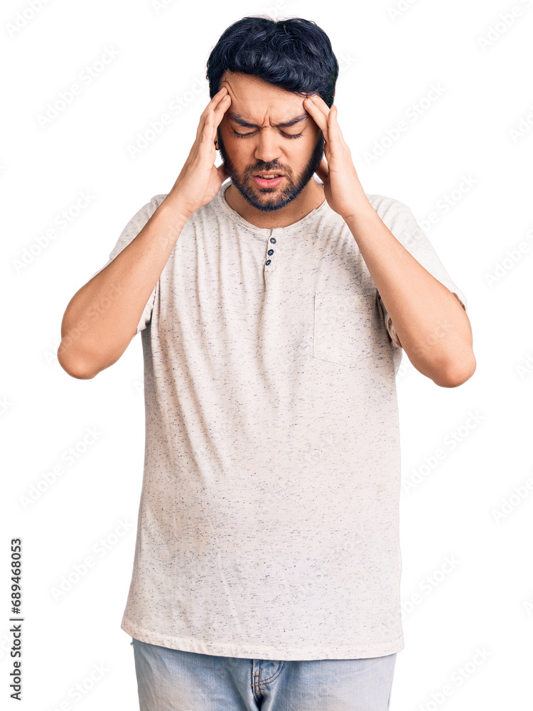 Young hispanic man wearing casual clothes with hand on head for pain in head because stress. suffering migraine. Young hispanic man wearing casual clothes with hand on head for pain in head because stress. suffering migraine.