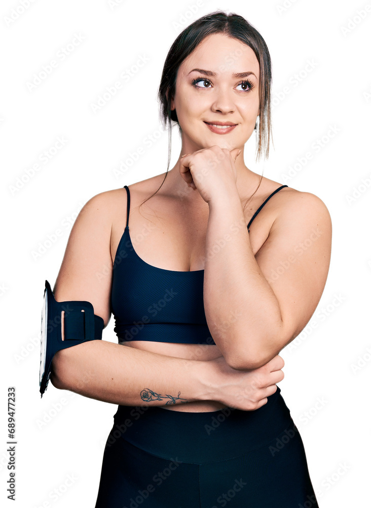 Young hispanic woman wearing sportswear with hand on chin thinking about question, pensive expression. smiling with thoughtful face. doubt concept. Young hispanic woman wearing sportswear with hand on chin thinking about question, pensive expression. smiling with thoughtful face. doubt concept.