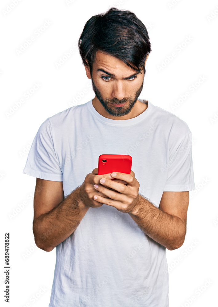 Hispanic man with blue eyes using smartphone typing message skeptic and nervous, frowning upset because of problem. negative person. Hispanic man with blue eyes using smartphone typing message skeptic and nervous, frowning upset because of problem. negative person.