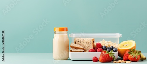 Wholesome lunchbox with wholemeal bread, fruit, and milk. photo