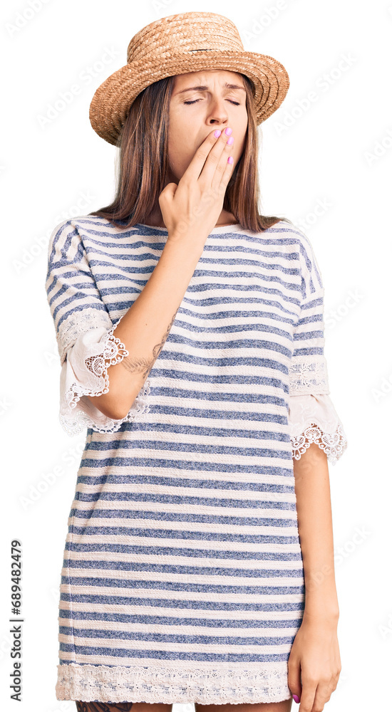 Beautiful caucasian woman wearing summer hat bored yawning tired covering mouth with hand. restless and sleepiness. Beautiful caucasian woman wearing summer hat bored yawning tired covering mouth with hand. restless and sleepiness.