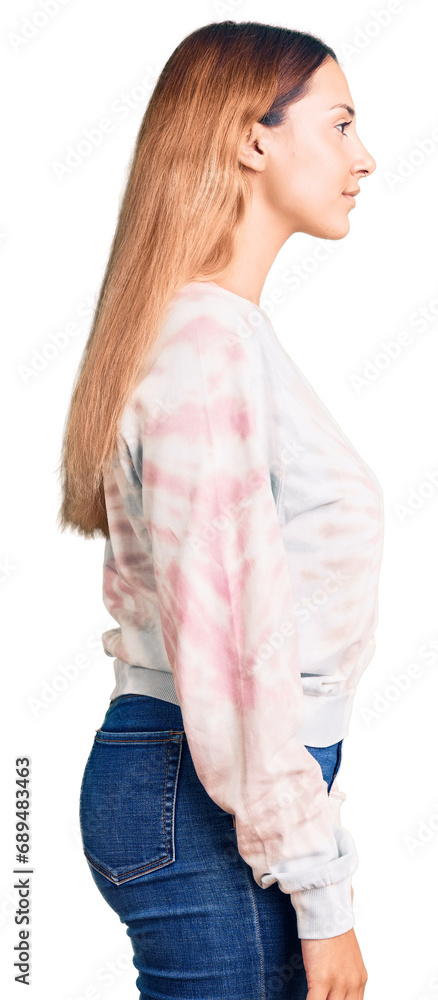 Beautiful young woman wearing casual tie dye sweatshirt looking to side, relax profile pose with natural face with confident smile. Beautiful young woman wearing casual tie dye sweatshirt looking to side, relax profile pose with natural face with confident smile.