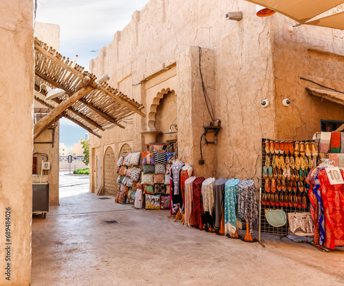 Shop with souvenirs and national dresses, scarves and fabrics in the reconstructed old part of the Dubai city - Al-Bastakiya quarter in the Dubai city, United Arab Emirates © svarshik