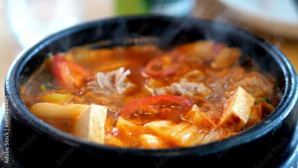 Budae jjigae is korean traditional food. It is loaded with Kimchi, spam, sausages, noodles. Budae jjigae is korean traditional food. It is loaded with Kimchi, spam, sausages, noodles.