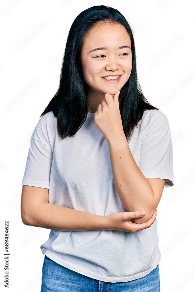 Young chinese woman wearing casual white t shirt with hand on chin thinking about question, pensive expression. smiling with thoughtful face. doubt concept. Young chinese woman wearing casual white t shirt with hand on chin thinking about question, pensive expression. smiling with thoughtful face. doubt concept.