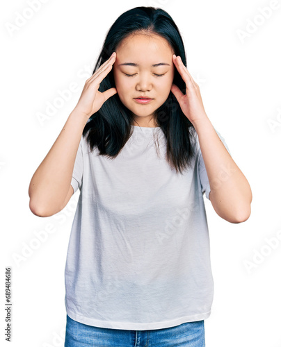 Young chinese woman wearing casual white t shirt with hand on head for pain in head because stress. suffering migraine.