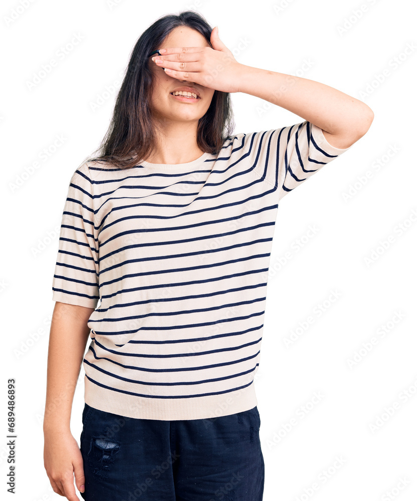 Brunette teenager girl wearing casual clothes and glasses smiling and laughing with hand on face covering eyes for surprise. blind concept. Brunette teenager girl wearing casual clothes and glasses smiling and laughing with hand on face covering eyes for surprise. blind concept.