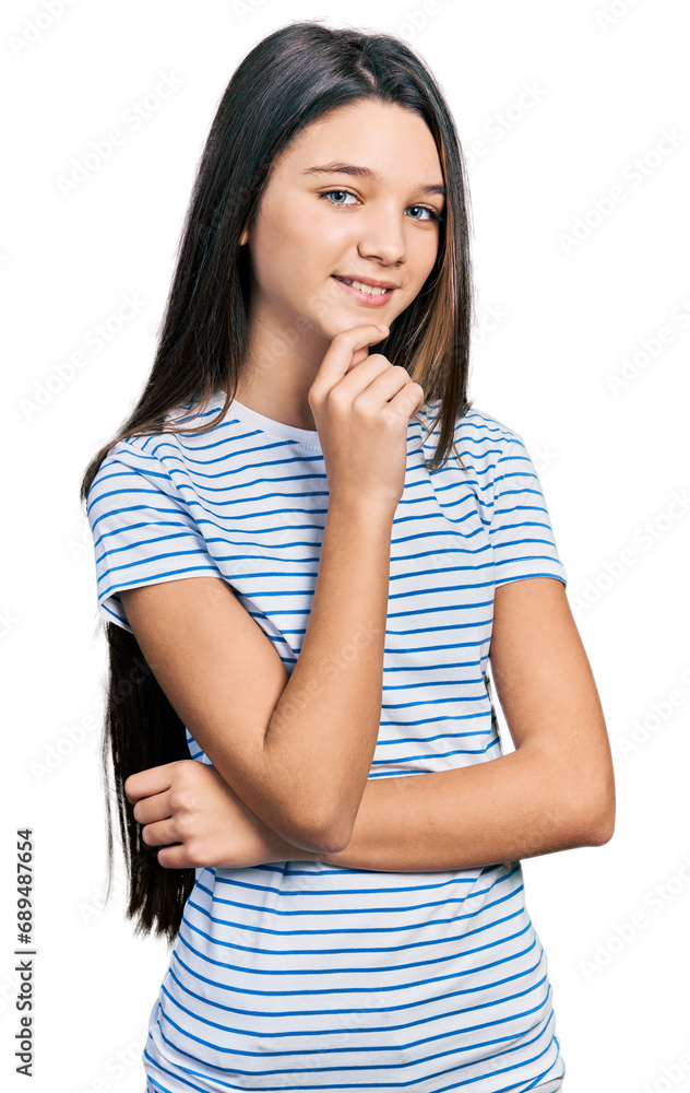 Young brunette girl with long hair wearing casual striped t shirt smiling looking confident at the camera with crossed arms and hand on chin. thinking positive. Young brunette girl with long hair wearing casual striped t shirt smiling looking confident at the camera with crossed arms and hand on chin. thinking positive.