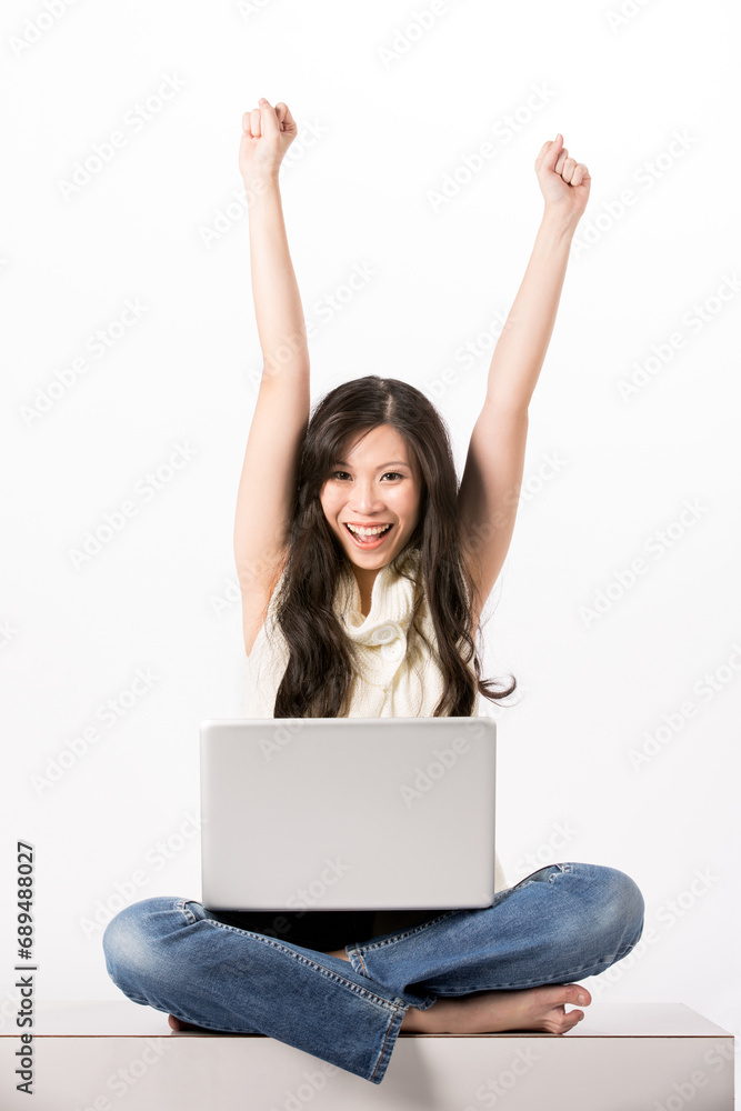 Woman using a laptop and celebrating. Woman using a laptop and celebrating.