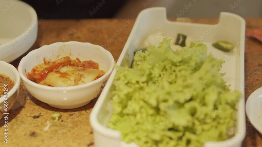 Eating Korean side dishes, Kimchi, with chopsticks at authentic Korean restaurant. Eating Korean side dishes, Kimchi, with chopsticks at authentic Korean restaurant.