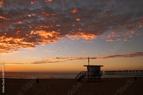 Lifeguard station with american flag on Hermosa beach at sunset © Filimon