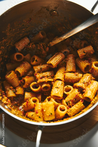 Sicilian Pesto Pasta. Pasta alla trapanese. Rigatoni pasta with pesto from cherry tomatoes and blanched almonds, basil and garlic plus anchovies and chili.