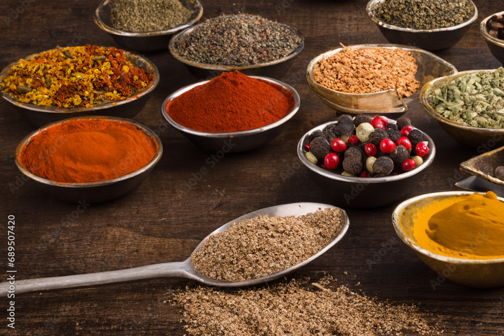 Spices and herbs in wooden bowls. Food and cuisine ingredients.
