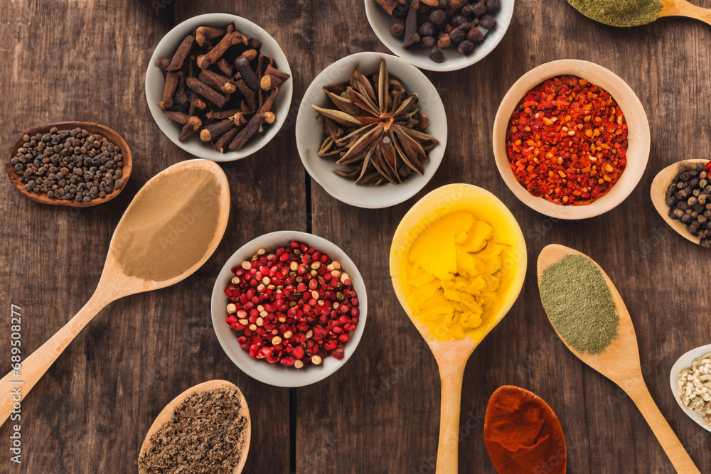 Spices and herbs in wooden bowls and spoons. Food and cooking ingredients. Spices and herbs in wooden bowls and spoons. Food and cooking ingredients.