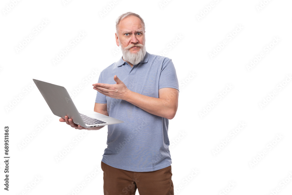 a cute grandfather with a gray beard and mustache is holding a laptop for work. e-business concept a cute grandfather with a gray beard and mustache is holding a laptop for work. e-business concept