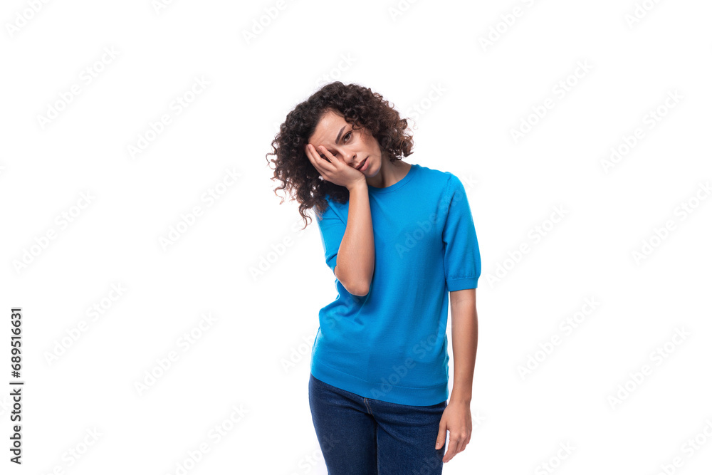 young woman with curly hairstyle above her shoulders feels tired young woman with curly hairstyle above her shoulders feels tired