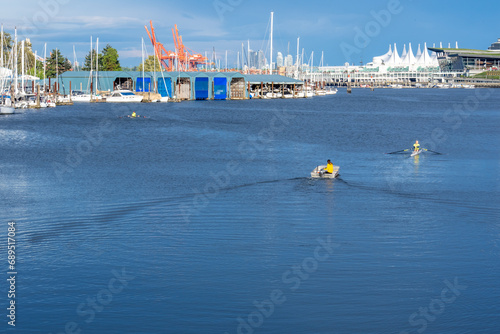 Kayakers on Serene City Waterscape with Urban Backdrop