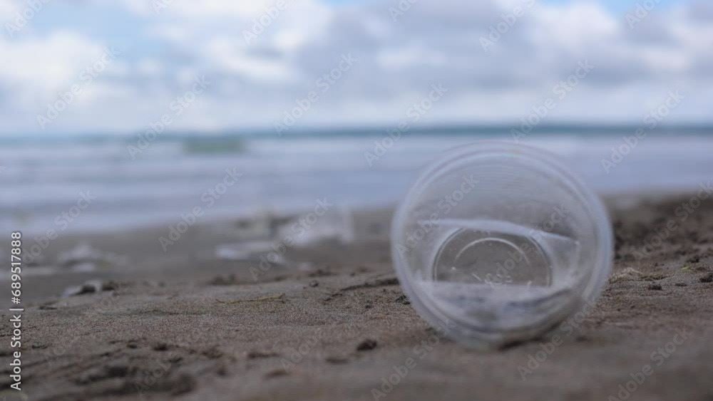 Plastic pollution on beach. Close-up of plastic garbage lays on sand, it will lead to environmental pollution and environmental problem. Concept of plastic pollution and environmental problems. Plastic pollution on beach. Close-up of plastic garbage lays on sand, it will lead to environmental pollution and environmental problem. Concept of plastic pollution and environmental problems.