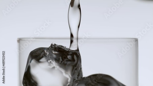 Soda Stream Flowing into a Glass with Ice Cubes photo