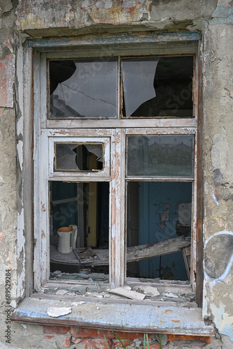 An old broken window in an abandoned house in Teriberka, Russia