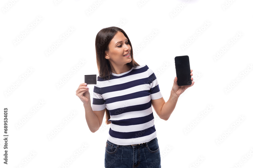 young smart brunette european lady of slim build dressed in black and white t-shirt offers advertising on smartphone holding credit card mockup young smart brunette european lady of slim build dressed in black and white t-shirt offers advertising on smartphone holding credit card mockup