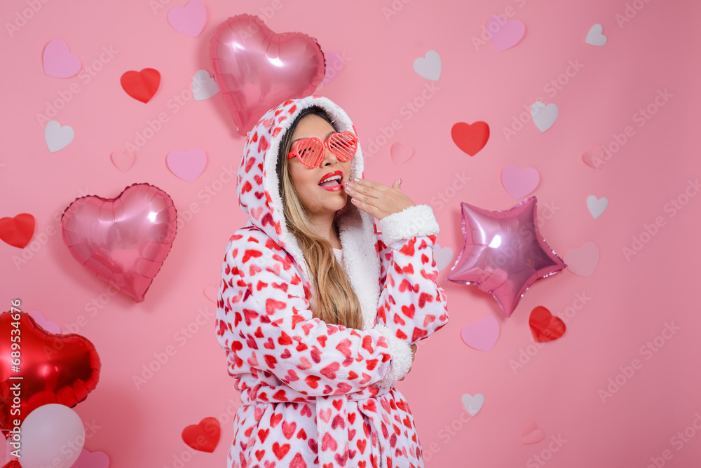 Portrait of woman wearing bathrobe with heart shaped figures with positive attitude. Valentine's day background. Portrait of woman wearing bathrobe with heart shaped figures with positive attitude. Valentine's day background.