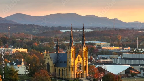 Catholic Church in golden hour light in Roanoke Virginia in autumn. Aerial view of Basilica of Saint Andrew. photo